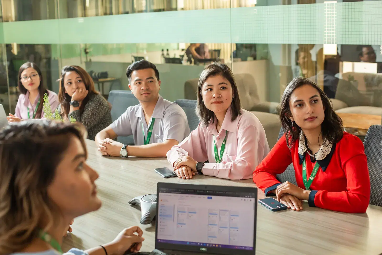 Team meeting for a project kickoff, with all team members attentively facing the presenter.